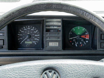 GoWesty electronic speedometer kit installed on front of Vanagon, showing digital display and vehicle wiring for MPH measurement.