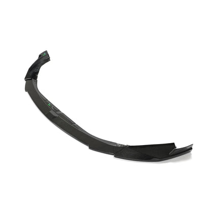 Dry carbon fiber front lip for BMW G80 M3 and G82 G83 M4 by K2 Industries, visible with sleek carbon fiber finish.