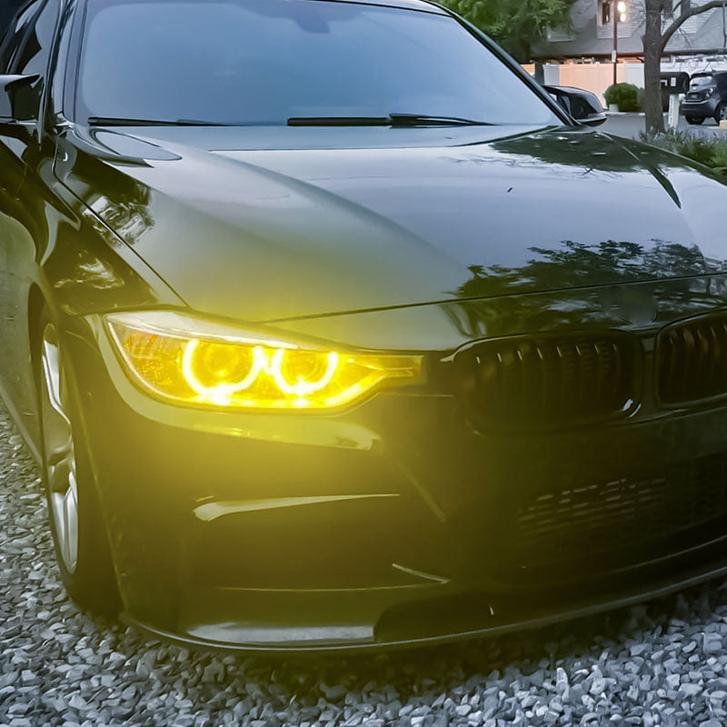 Vekto RGB LED DRL modules installed in BMW F30/F31/F35 2012-2015 Xenon headlights, showing vibrant lighting details.