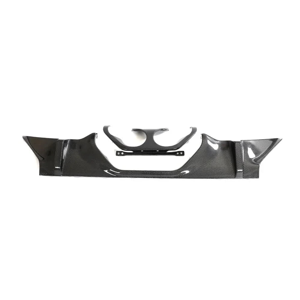 Carbon fiber rear diffuser for BMW M2 G87 coupe by K2 Industries, showing sleek aerodynamic design and textured carbon fiber surface.