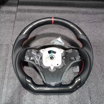 Hydro-Dip carbon steering wheel for BMW E90/E92/E93 M3, Vekto brand, showing detailed black carbon finish on the steering wheel.