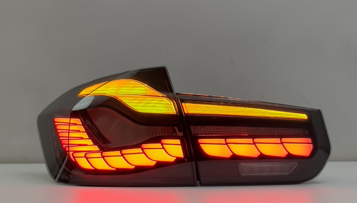 Vekto GTS Dragon Scale LED tail lights installed on a BMW F30/F35/F80 2012-2019, showcasing a sleek, illuminated tail light design.