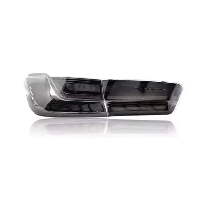 Vekto GTS OLED tail lights for BMW G20 3 Series and G80 M3 in cherry red and smoked finish, showing illuminated LED design.