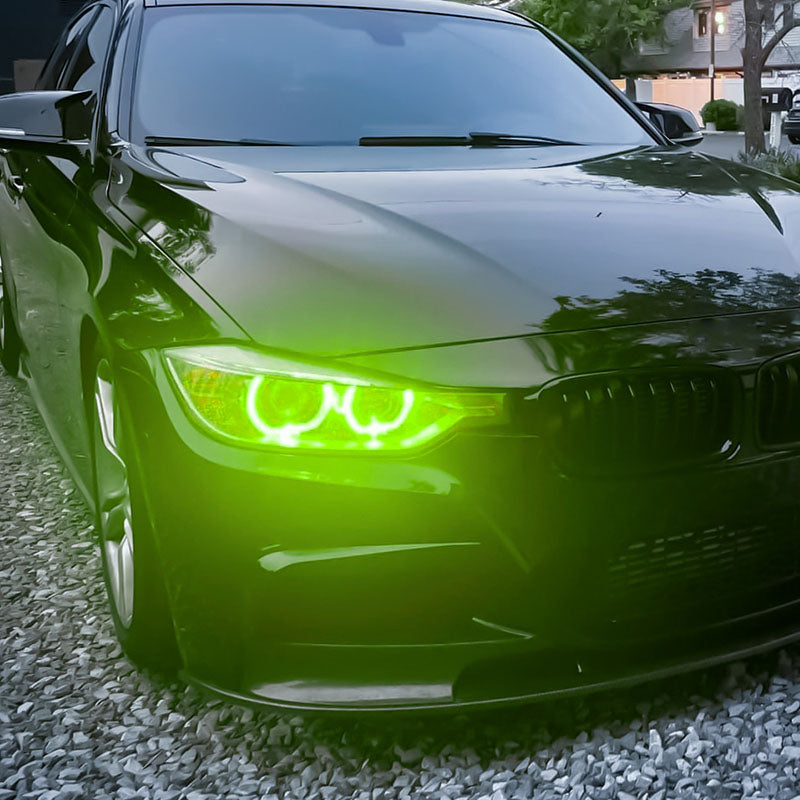 Vekto RGB LED DRL modules installed in BMW F30/F31/F35 pre-LCI xenon headlights, showing colorful LED daytime running lights.