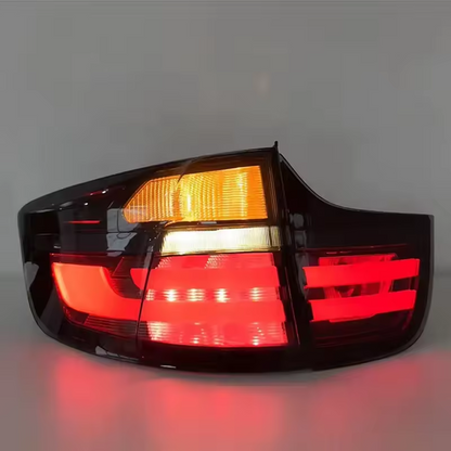 Vekto LED taillights for BMW X6 E71 2007-2014, showing sleek red and clear lens tail light assembly with wiring connectors.