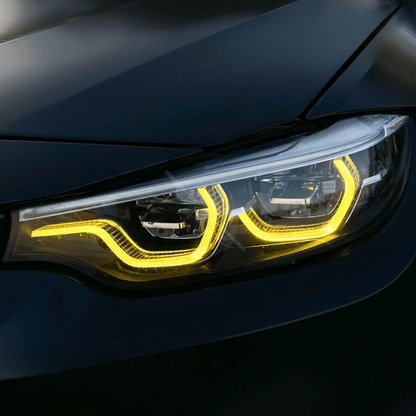 Vekto RGB LED DRL module kit installed in BMW F80 M3 and F82/F83 M4 LCI headlights, showcasing vibrant lighting features.