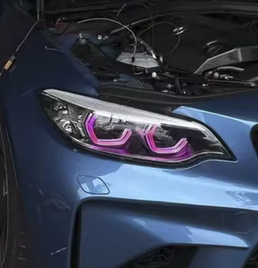 Vekto RGB LED DRL headlight modules for BMW F22/F23 2 Series and F87 M2 LCI, 2018-2020, showing illuminated colorful daytime running lights.