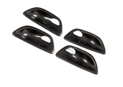 Carbon fiber interior door handle trim set for BMW F10 5 Series by K2 Industries, performance-style door handle covers.