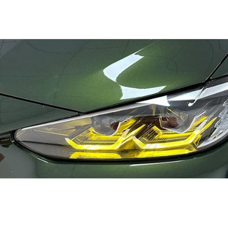 Vekto RGB LED DRL module kit installed in BMW G80 M3, G82 M4, G22 4 Series headlights, showcasing vibrant lighting design.