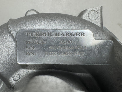 Close-up of a metallic turbocharger housing with an embossed metal nameplate reading TURBOCHARGER, model 06K145874T, and serial details.