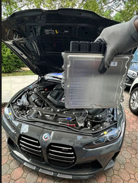 BMW ECU full unlock and Bootmod3 tuning kit, showing the ECU module with tuning software interface on a computer screen.