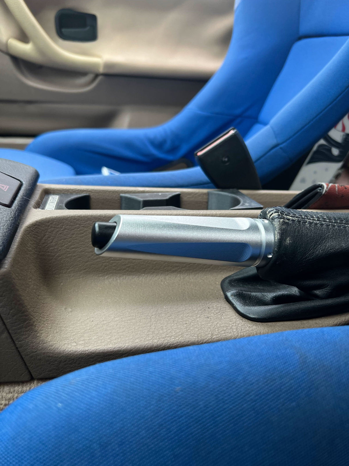 BMW aluminum handbrake cover by K2 Industries, showcasing a sleek, metallic hand brake cover for BMW vehicles.