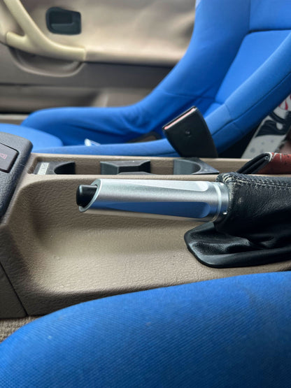 BMW aluminum handbrake cover by K2 Industries, showcasing a sleek, metallic hand brake cover for BMW vehicles.