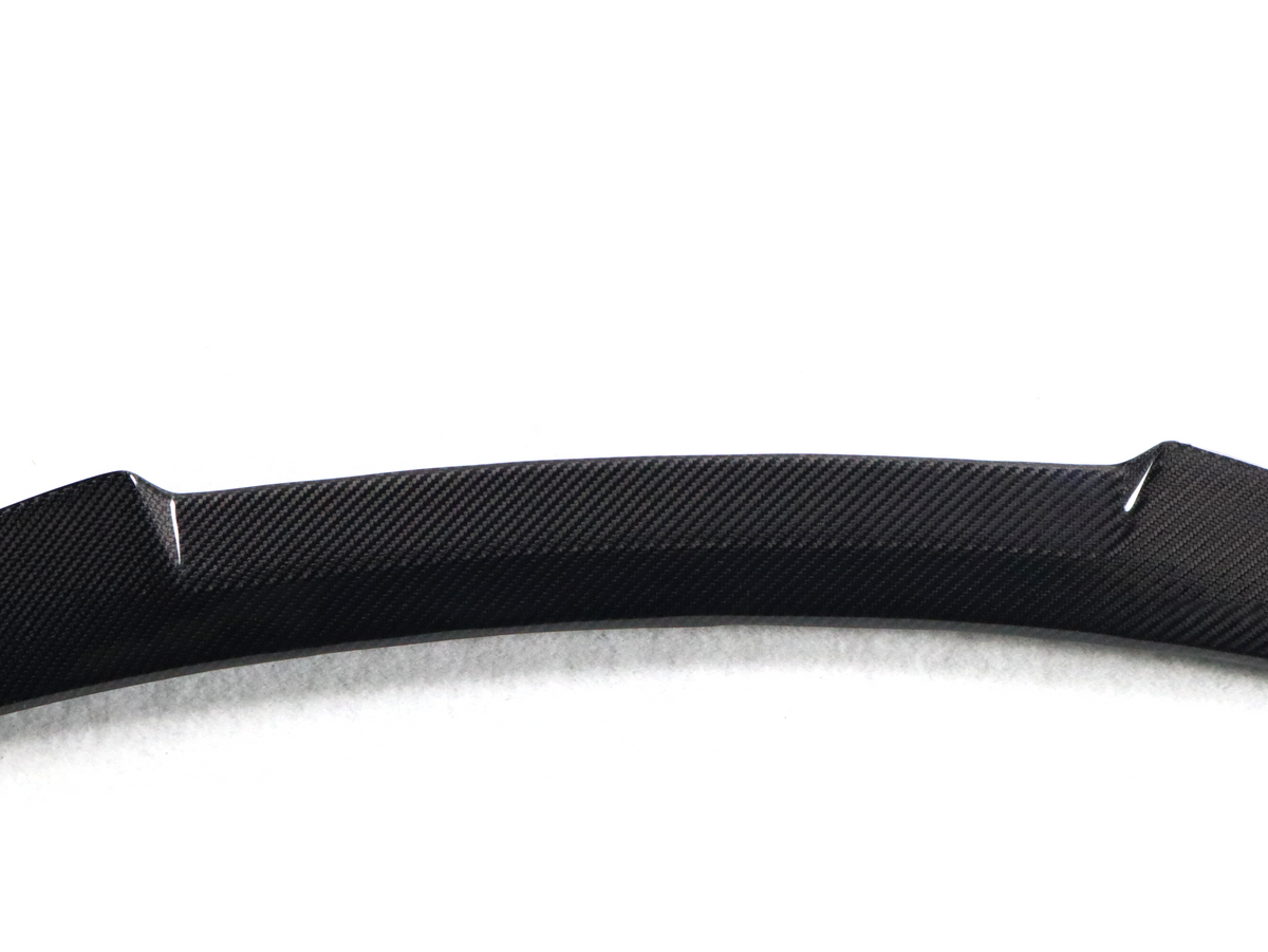 BMW F82 M4 carbon fiber trunk spoiler with V style design, featuring sleek aerodynamic contours and a glossy finish.