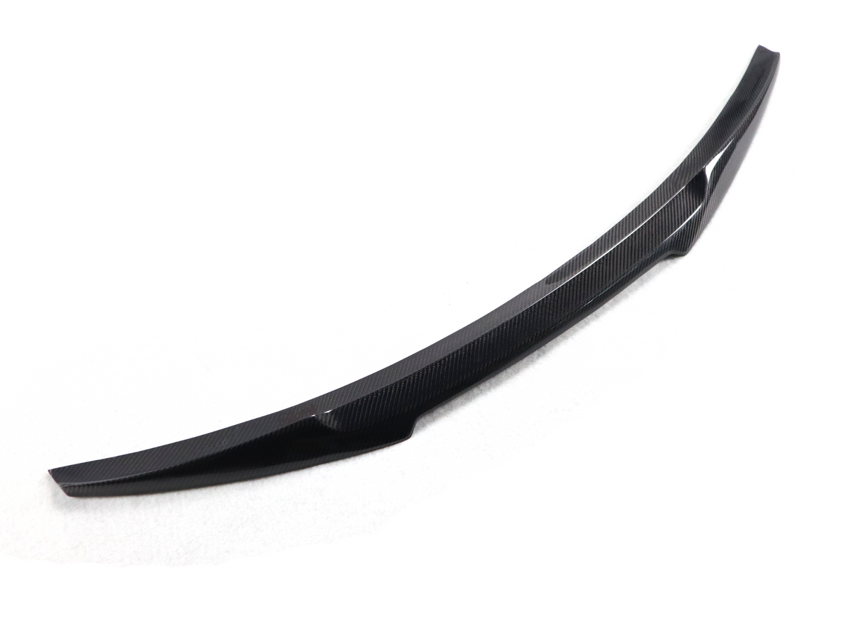 BMW F82 M4 V Style trunk spoiler in carbon fiber, sleek aerodynamic design for enhanced performance and sporty look.
