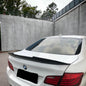 Carbon fiber BMW F10 trunk spoiler by Palenon Performance, rear view showing aerodynamic design and glossy finish.