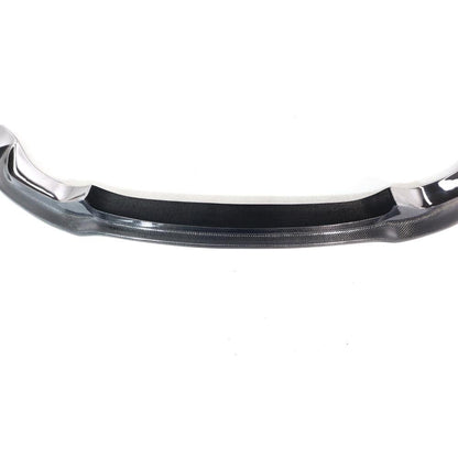 Carbon fiber Vorsteiner front lip for BMW F80 M3 and F82/F83 M4, showcasing sleek, lightweight aerodynamic design.