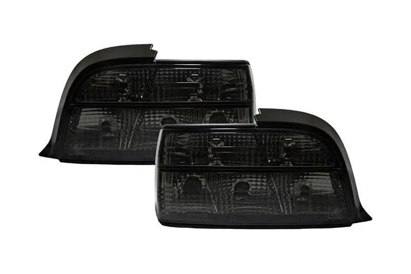 BMW E36 coupe smoked and clear tail lights by K2 Industries, showing the sleek design and lens details of the tail light assembly.