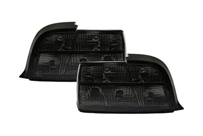 BMW E36 coupe smoked and clear tail lights by K2 Industries, showing the sleek design and lens details of the tail light assembly.
