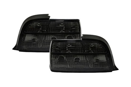 BMW E36 coupe smoked and clear tail lights by K2 Industries, showing the sleek design and lens details of the tail light assembly.