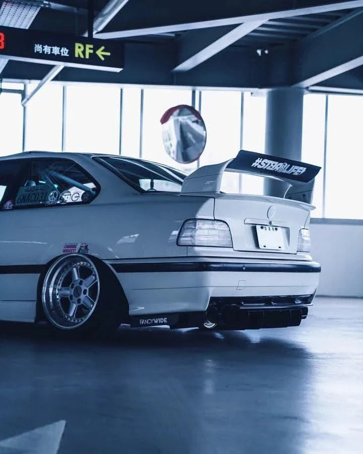 K2 Industries custom clear tail lights for BMW E36 coupe and convertible, model years 1992-1999, shown on vehicle.