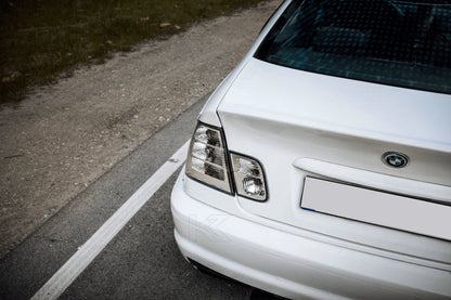 K2 Industries BMW 3-Series E46 coupe clear tail lights installed on a 1998-2006 model, showing the sleek, transparent lens design.