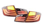 Black LED taillights for BMW 5-Series F10 sedan, 2010-2012, by K2 Industries, showing the sleek tail light design and LED illumination.