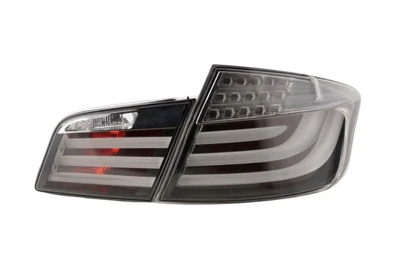 Black LED tail lights for BMW 5-Series F10 sedan (2010-2012) by K2 Industries, showing the sleek rear lighting design.