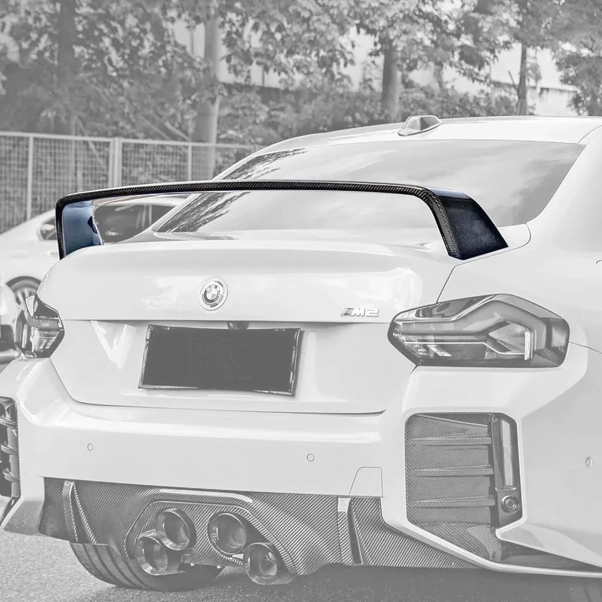 BMW 2 Series G87 M2 carbon fiber MP style wing by K2 Industries, showcasing aerodynamic design and sleek carbon fiber finish.