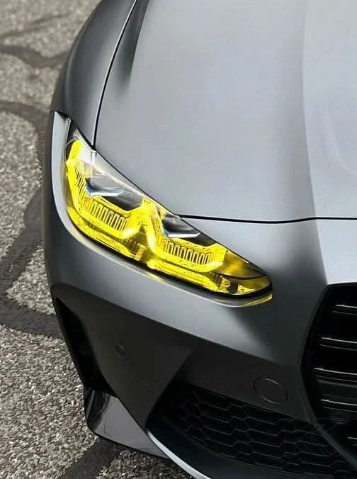 Vibrant yellow BMW 3/4 Series G80 G82 DRL module by K2 Industries installed on a vehicle's front lighting system.