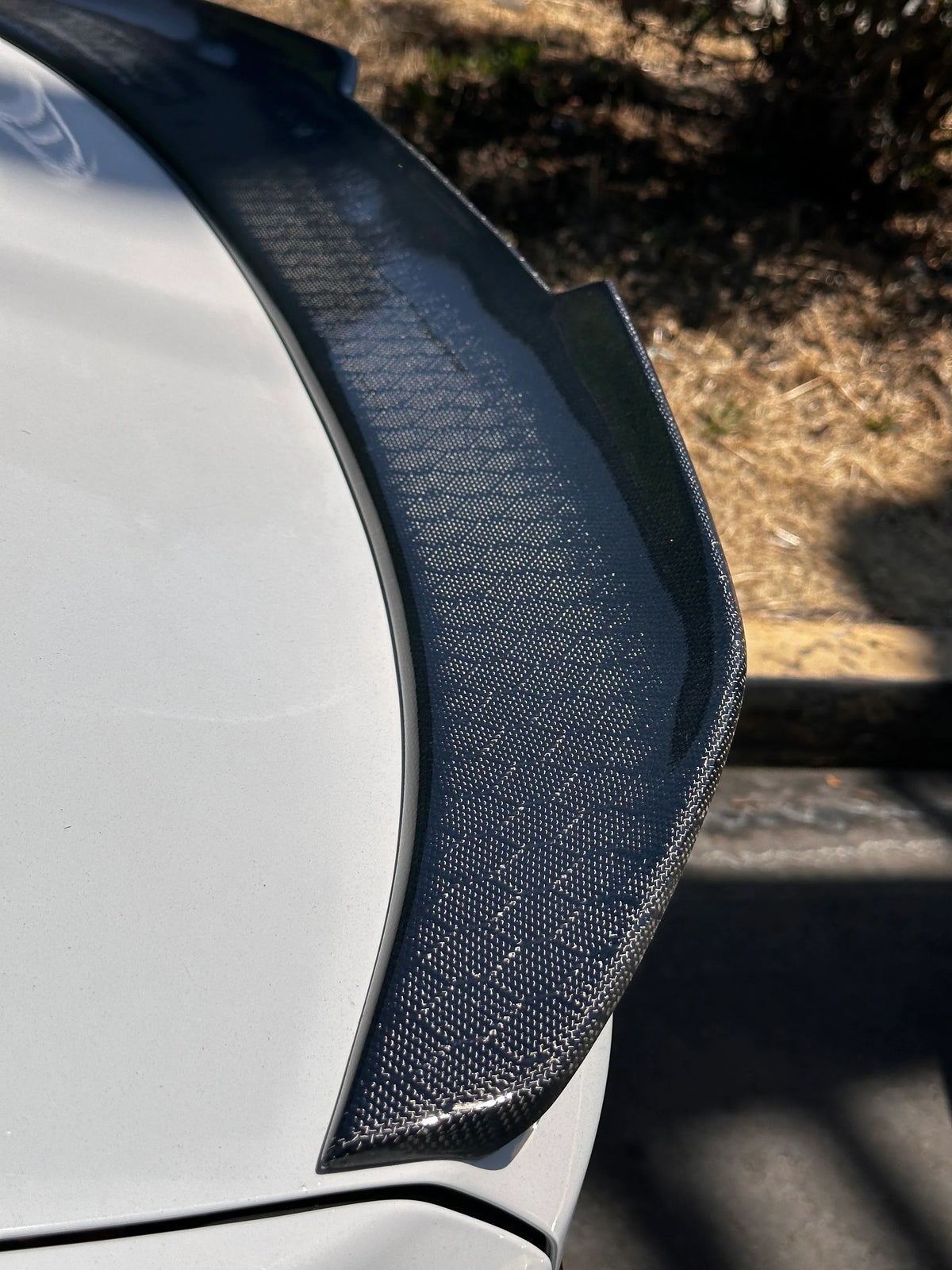 Carbon fiber BMW G30 and F90 M5 PSM trunk spoiler by Palenon Performance, showcasing aerodynamic design on a sleek M5 vehicle.