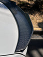 Carbon fiber BMW G30 and F90 M5 PSM trunk spoiler by Palenon Performance, showcasing aerodynamic design on a sleek M5 vehicle.