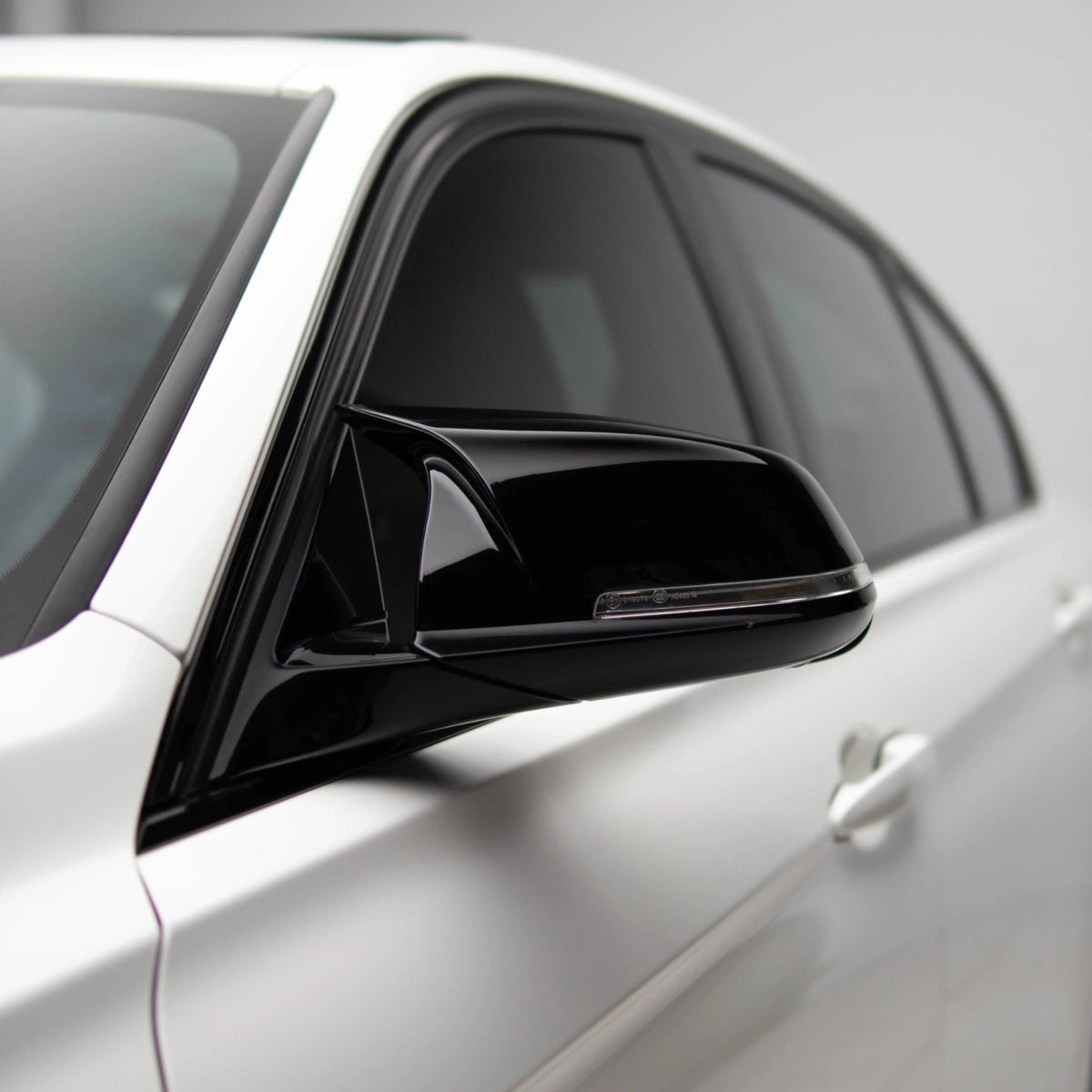 High gloss black BMW mirror cover by Palenon Performance for F2X, F3X, F87 M2, and E84 X1 models, made of durable ABS.
