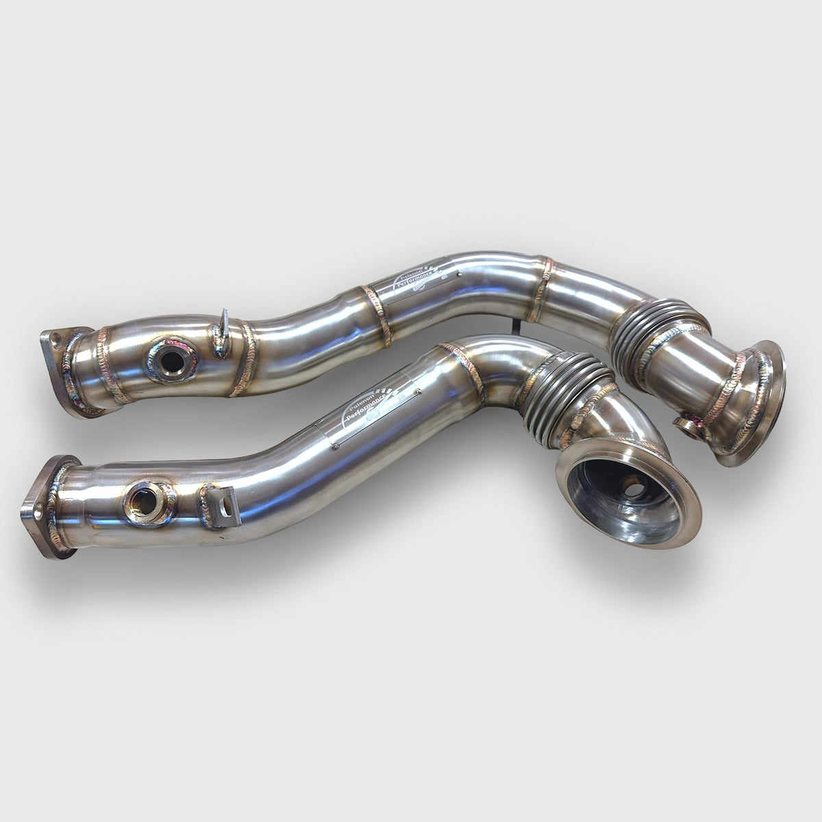 Palenon Performance N54 racing downpipe for BMW 1M, 135i, 335i, 335is, and 335xi models, showing the metal pipe and flanges.