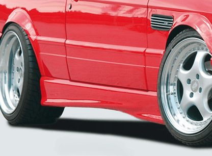 K2 Industries BMW E30 Sedan/Wagon side skirts V2 installed on vehicle, showcasing sleek aerodynamic design and fitment details.