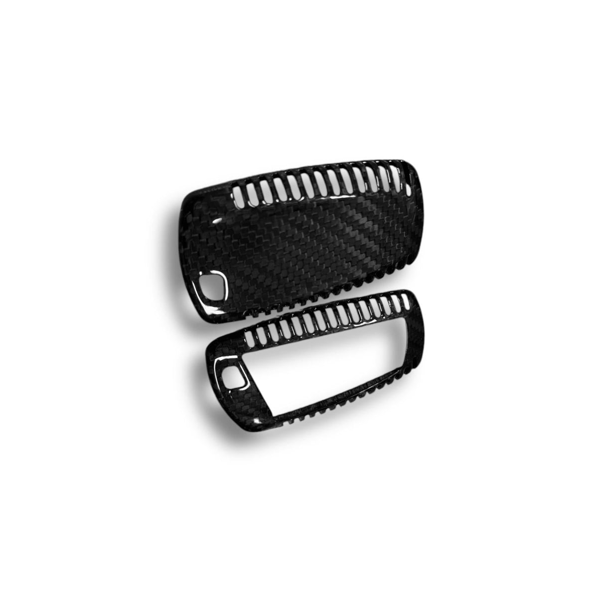 BMW X5, X6, X1 carbon fiber key cover by Palenon Performance, showcasing sleek, textured black carbon fiber surface on a key fob.