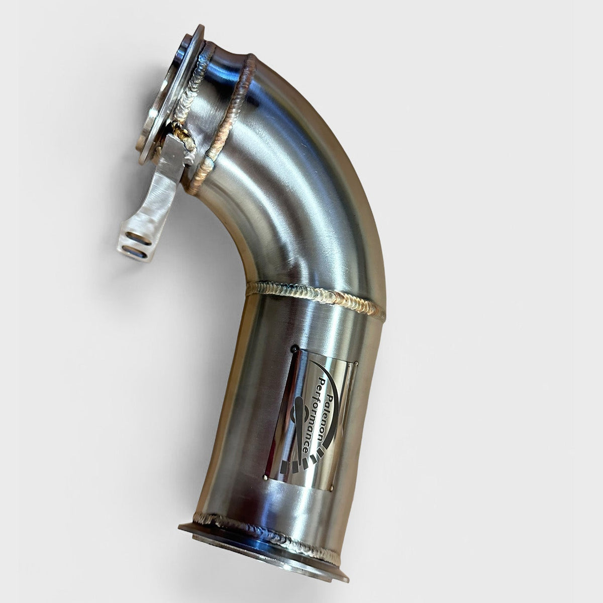 BMW F90 M5 racing downpipe by Palenon Performance, showcasing the high-performance exhaust component with intricate metal details.