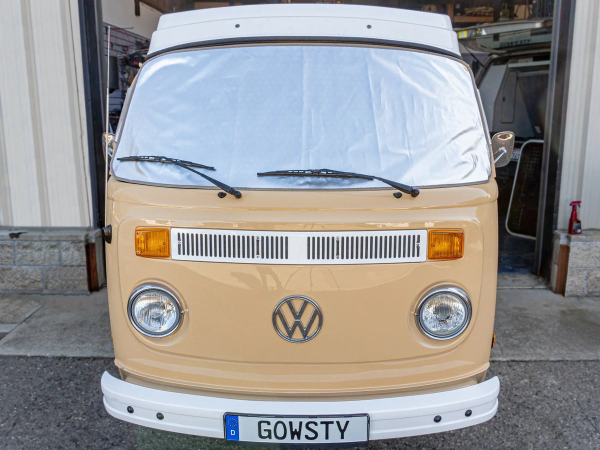 GoWesty Snow & Sun Shade window cover installed on a bus, providing sun protection and privacy for vehicle windows.