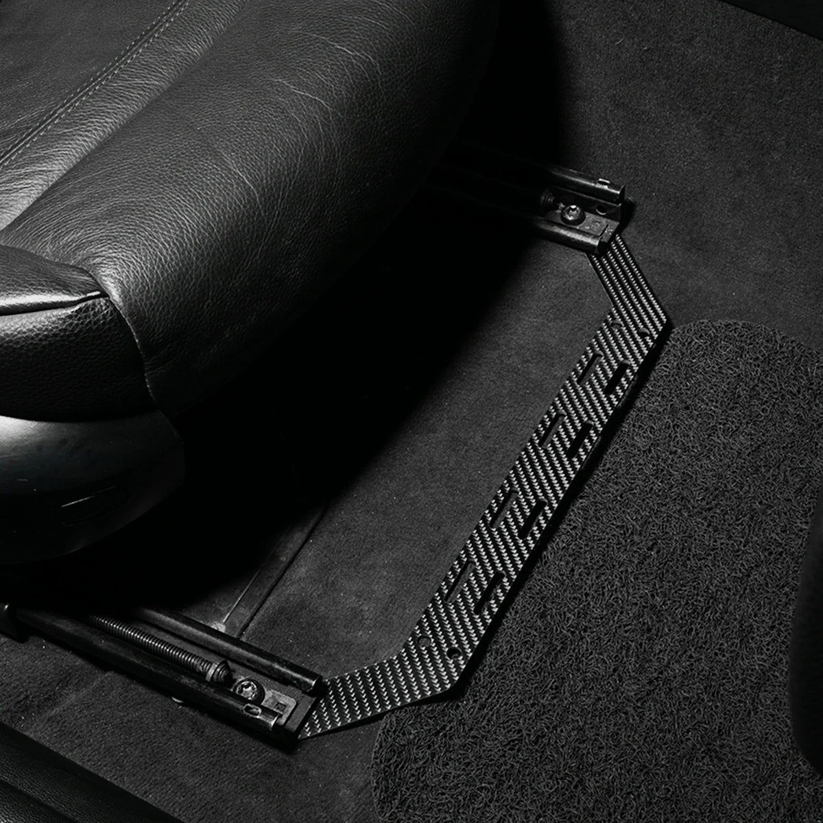 K2 Industries carbon fiber fire extinguisher seat mount bracket for BMW 3 Series E90 E91 E92 E93, 2005-2013, shown installed in vehicle.