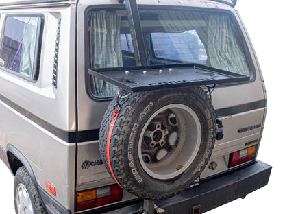 GoWesty tray on spare bracket installed on a Bus/Vanagon, showing the sturdy mounting setup for extra storage.