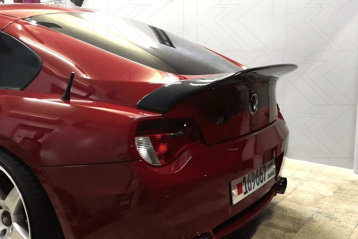 Black BMW Z4 E85/E86 Hyper Duck Tail Trunk Spoiler V2 by K2 Industries on a 2003-2008 coupe with aerodynamic design