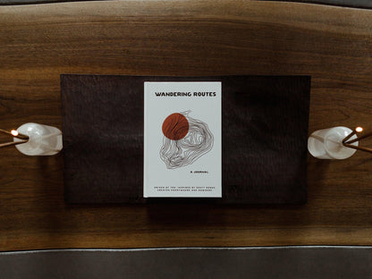 Open Wandering Routes Journal by GoWesty, featuring detailed maps and travel literature for adventure planning.