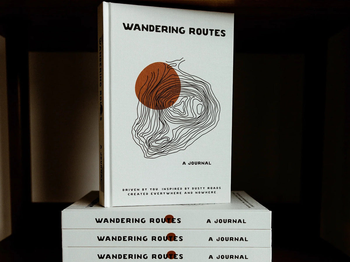 Open Wandering Routes Journal by GoWesty, featuring maps and literature for travelers exploring scenic routes and adventures.