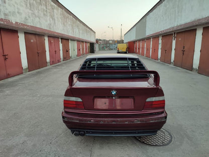 Black windshield louvers for BMW E36 Coupe Series 3 by K2 Industries, installed on the rear window of a 1992-1999 model.