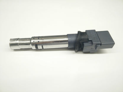 Genuine OEM Audi VW 3.6L engine ignition coil for Q7, University VW Audi brand, shown in close-up with electrical connectors.