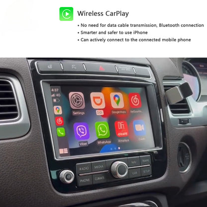Car stereo touchscreen showing the Apple Wireless CarPlay interface, installed in a vehicle dashboard with climate and radio controls below, with explanatory text at the top about wireless CarPlay connectivity.
