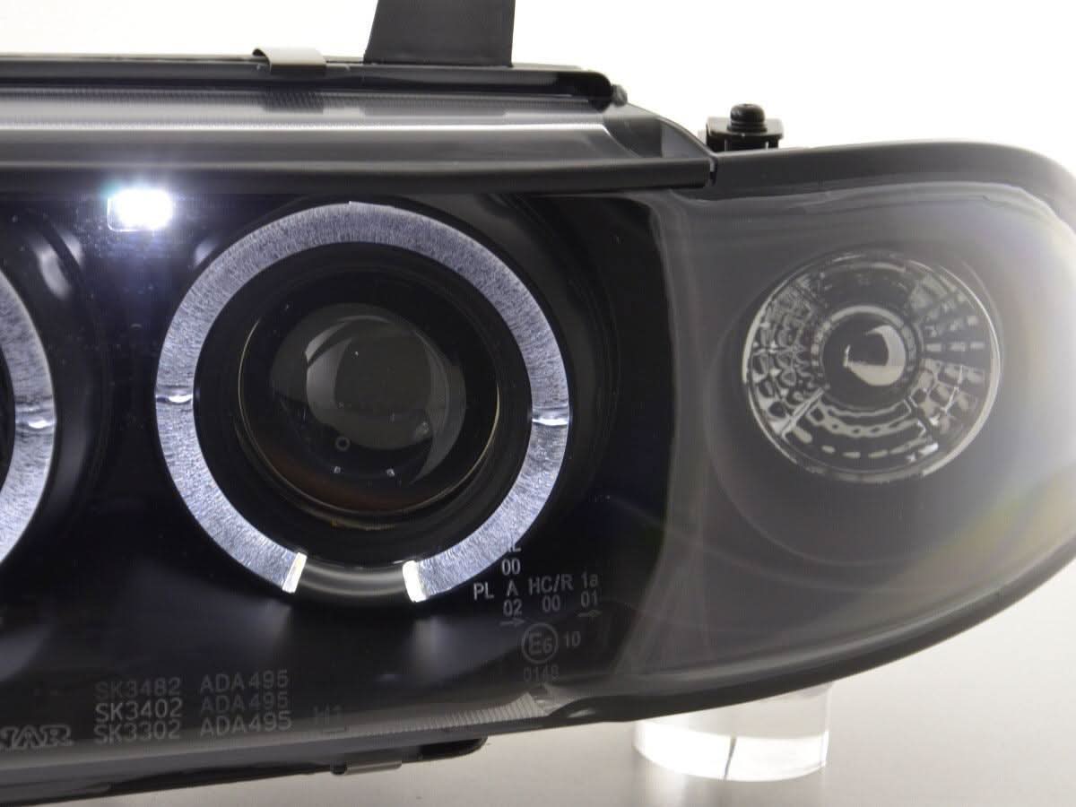 Black angel eye headlights for Audi A4 B5 8D (1995-1999) by K2 Industries, featuring sleek design and modern illumination.