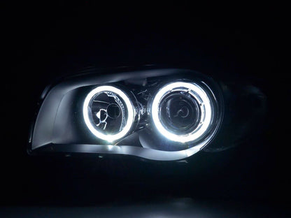 BMW 1-Series E81/E82/E87/E88 LED headlights with angel eyes by K2 Industries, showing the front view with illuminated rings.