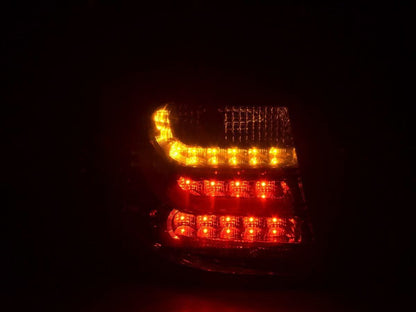 BMW 1 Series E87/E81 3/5-door red smoked LED tail lights by K2 Industries, vehicle rear view with illuminated taillights.