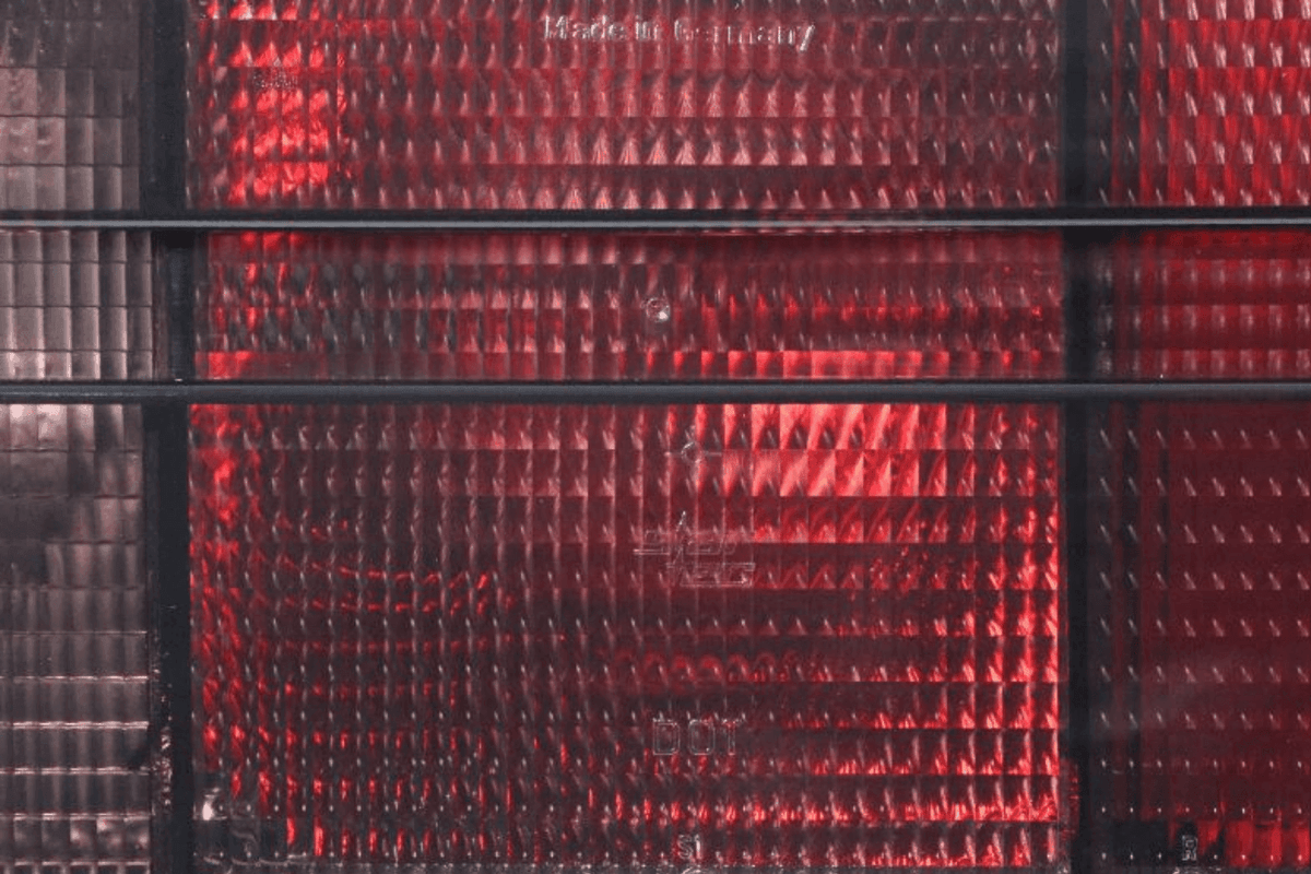 BMW 3 Series E30 original Startec taillights by K2 Industries, 1984-1991, showing red and clear lens with mounting brackets.